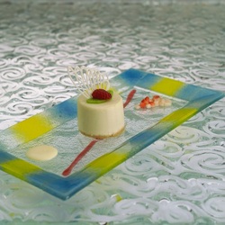 Turgla's 14.5 multi purpose plate with blue and yellow brush strokes is available in clear or frosted glass.